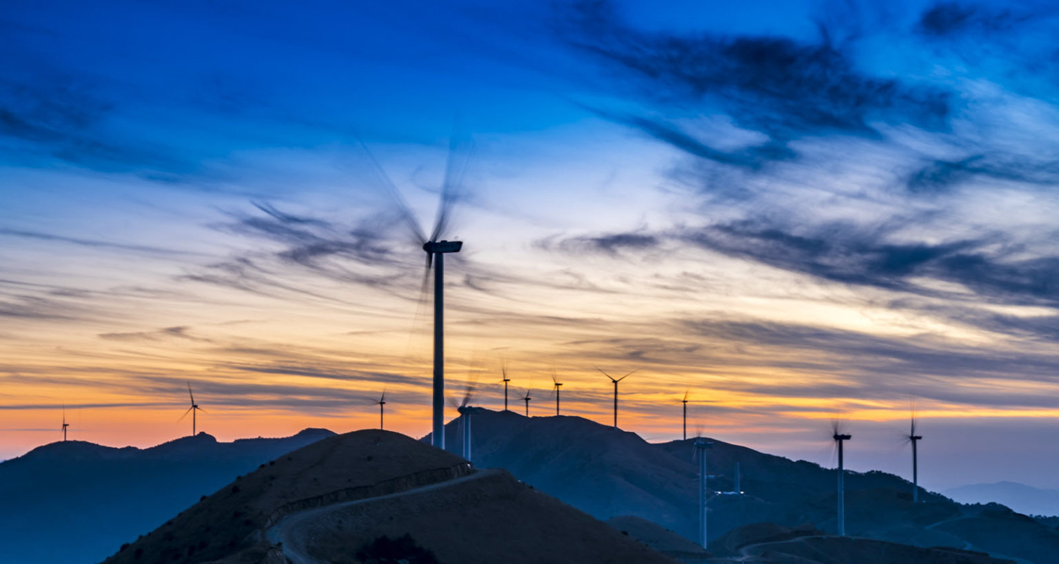 Wind turbine field at sunset on a mountain