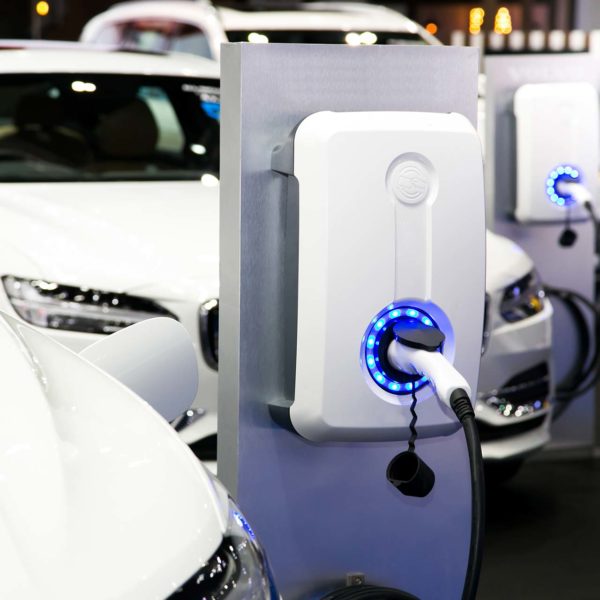 Electric vehicle charging station with cars plugged in