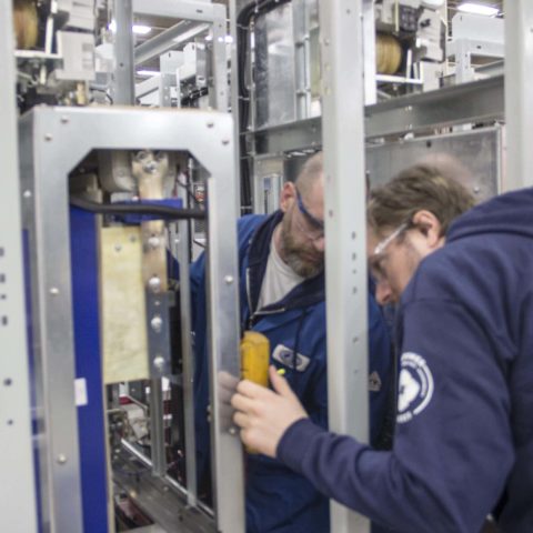 Two people working on Dynapower viridity racks