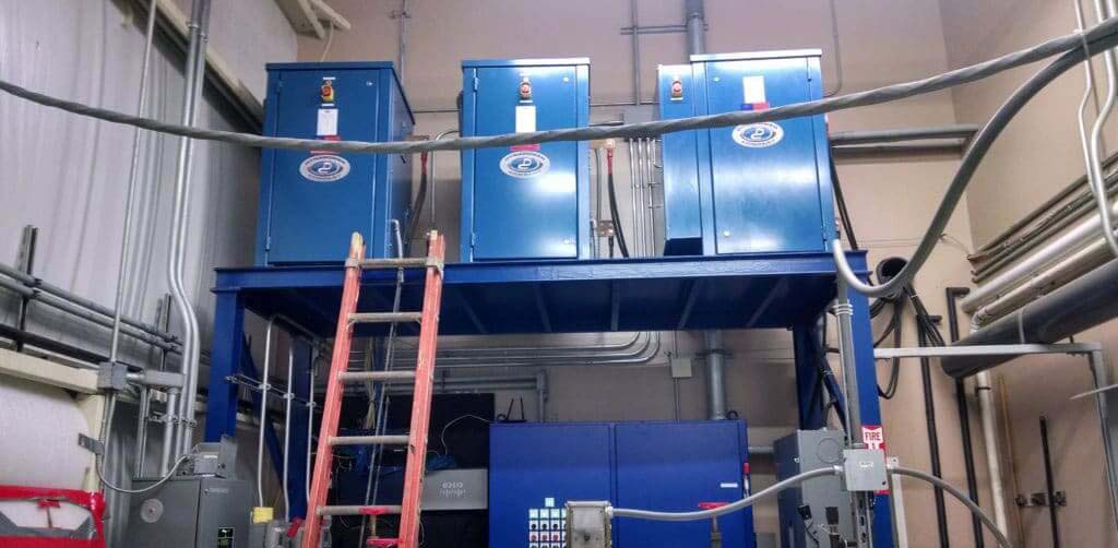 three rectifier units in storage at Dynapower facility
