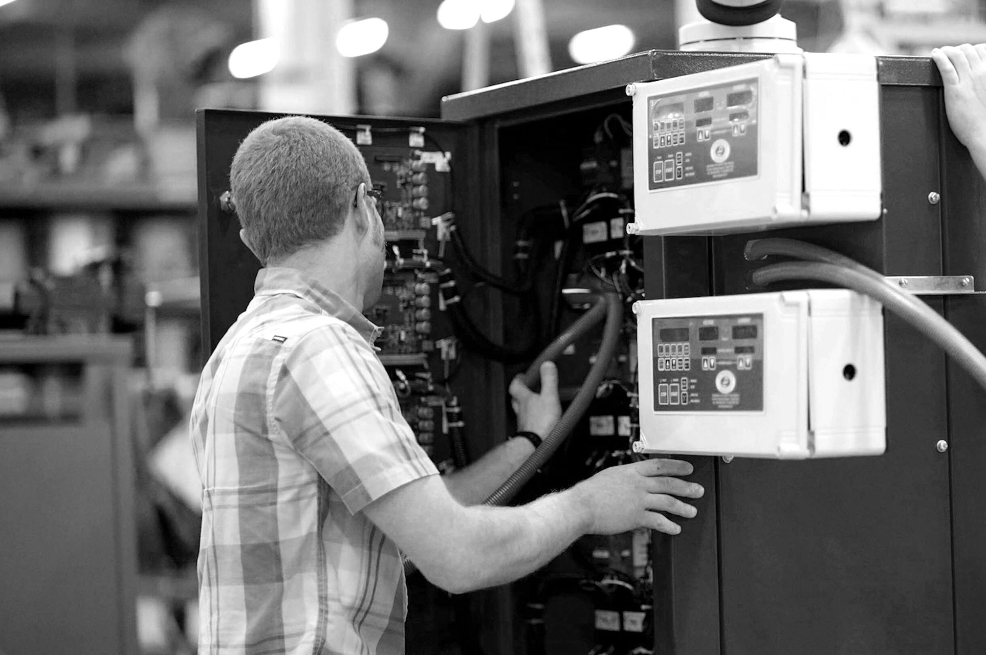 black and white, dynapower employee working on a machine