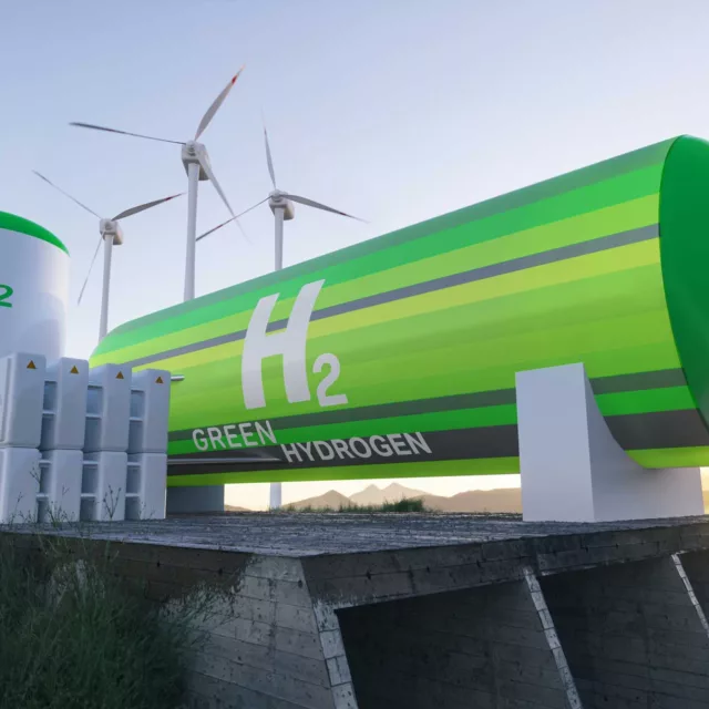 green hydrogen tank that reads "H2" sits next to wind turbines and solar panels